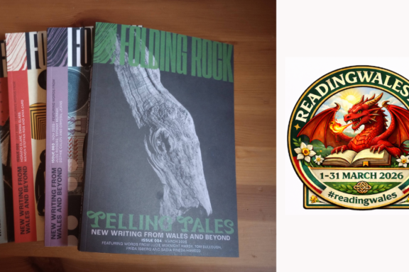 The first four print issues of Folding Rock magazine spread out on a desk, showcasing writing from and about Wales
